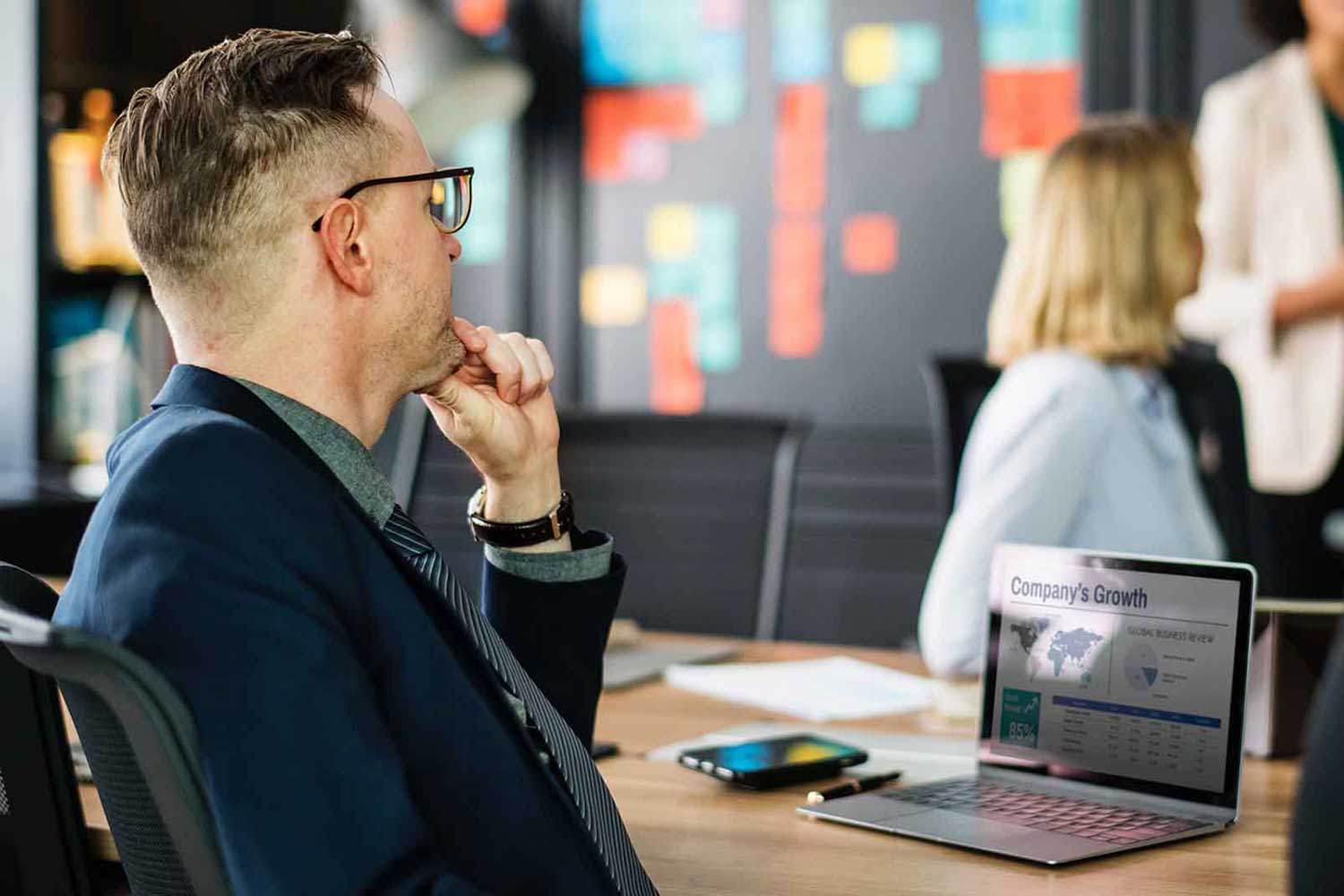 a man sitting in front of a laptop computer.