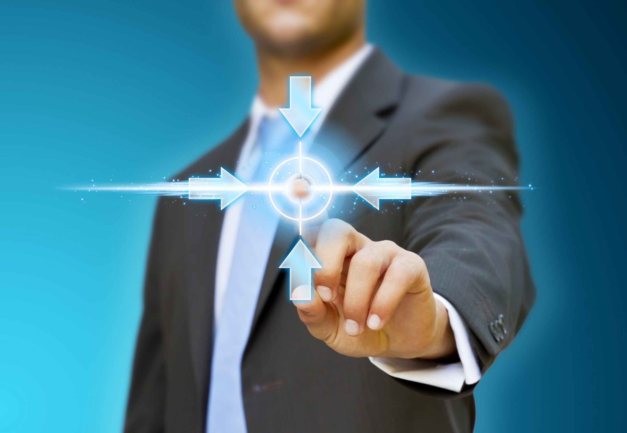 a man in a suit pointing to a button.