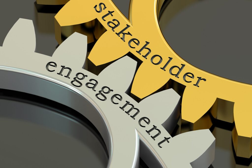 a close up of two gears with the words stakeholder and engagement.