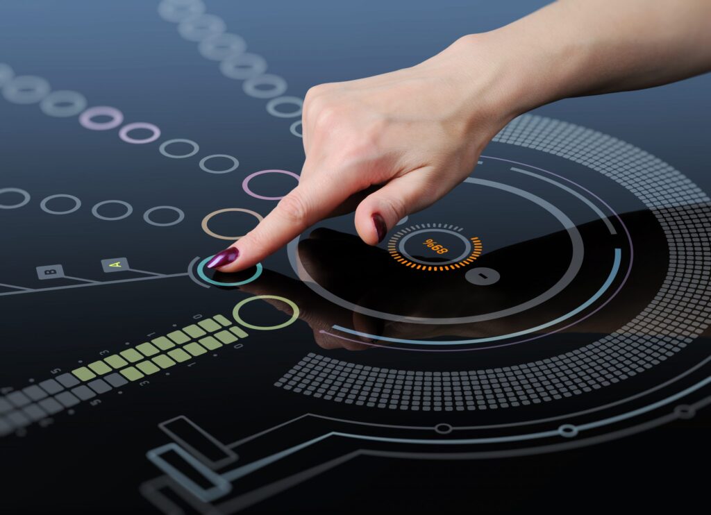 a woman's hand touching a button on a futuristic surface.