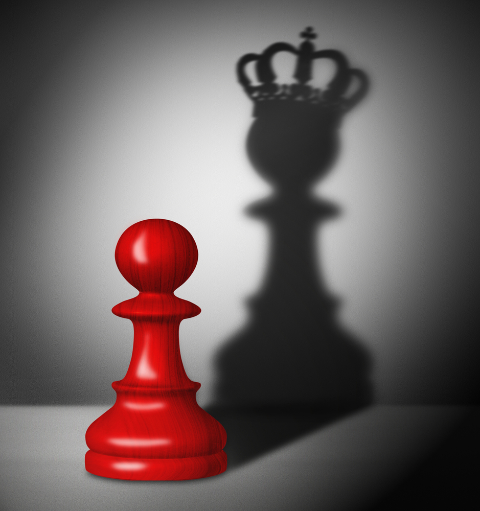 A red chess piece with a crown in front of it signifying digital transformation