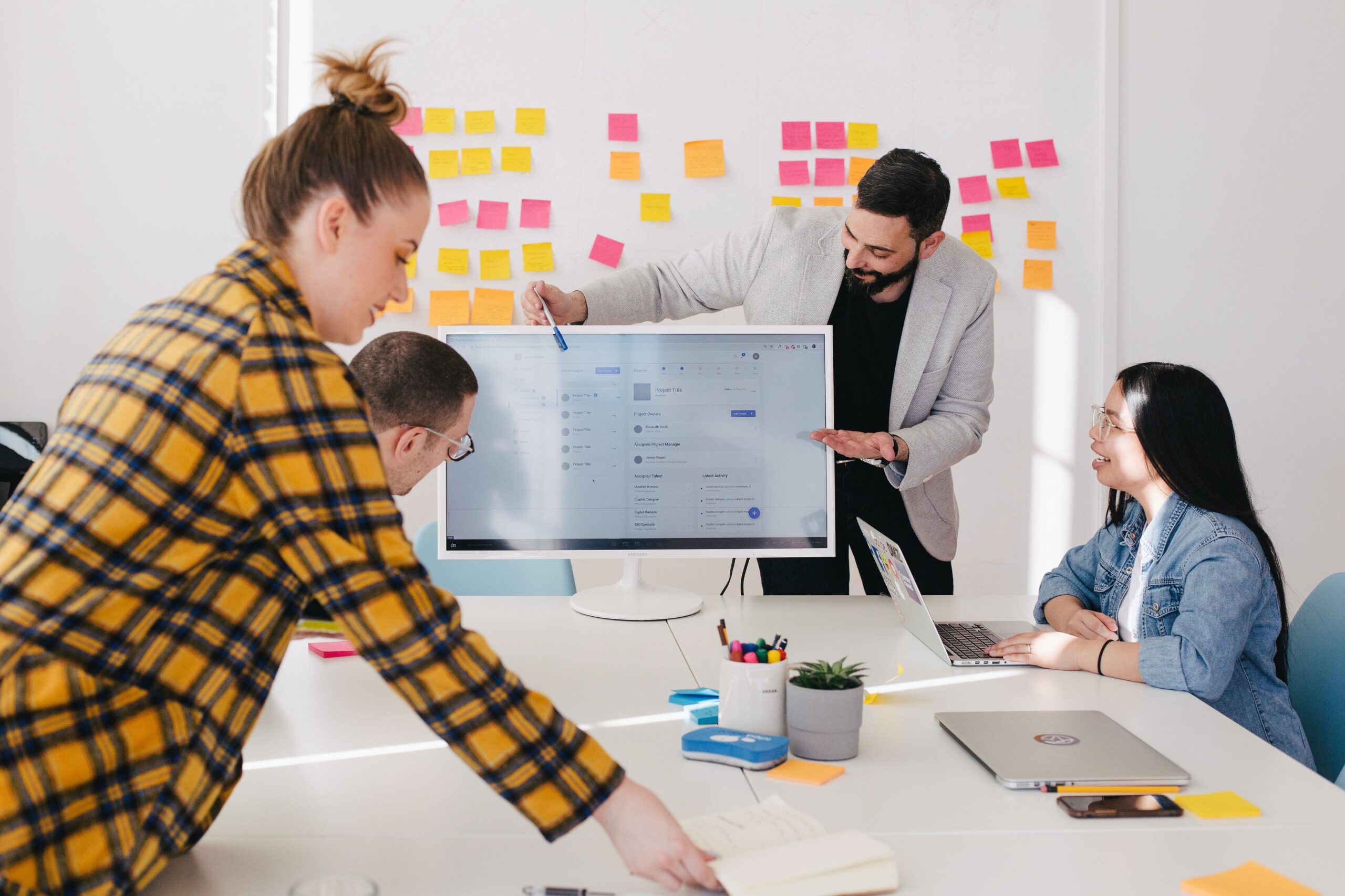 A group of people sitting around a table in a meeting room.