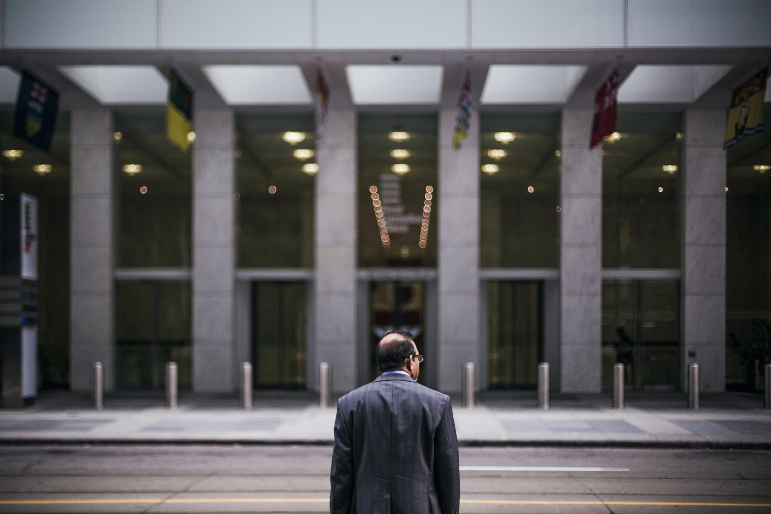 A man in a suit walking down the street.