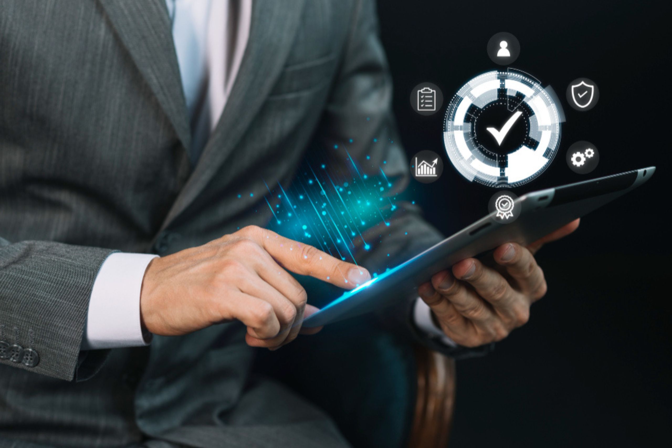 A person in a suit uses a tablet, with digital icons and a checkmark graphic floating above, representing business technology and workflow automation.