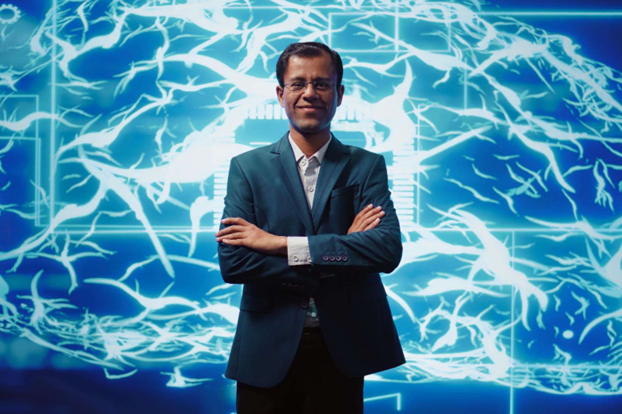 A man in a suit stands with arms crossed in front of a digital graphic depicting neural networks on a blue background, symbolizing the confidence and forward-thinking required to shape a successful AI strategy.